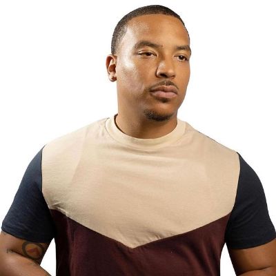 Brian is wearing a t shirt with black sleeves.